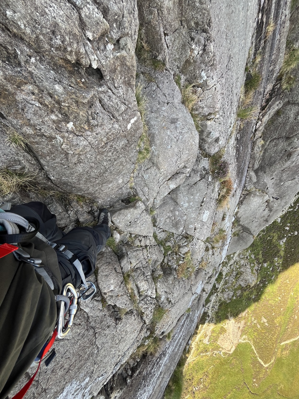 View down a steep rock face during alpine training